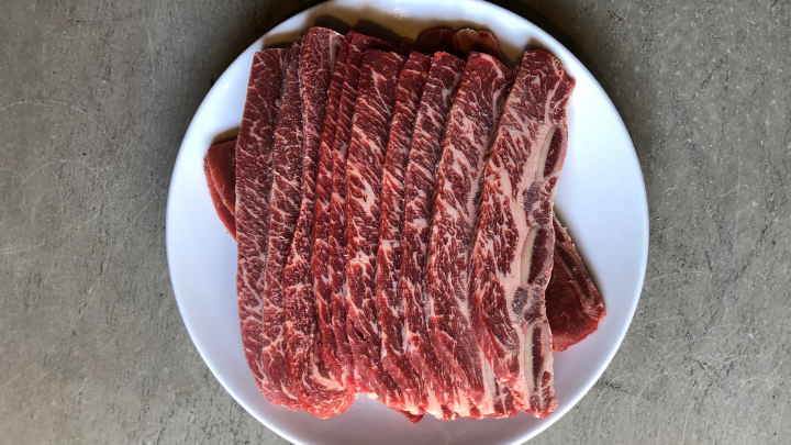 short ribs cut flanken style on a white plate