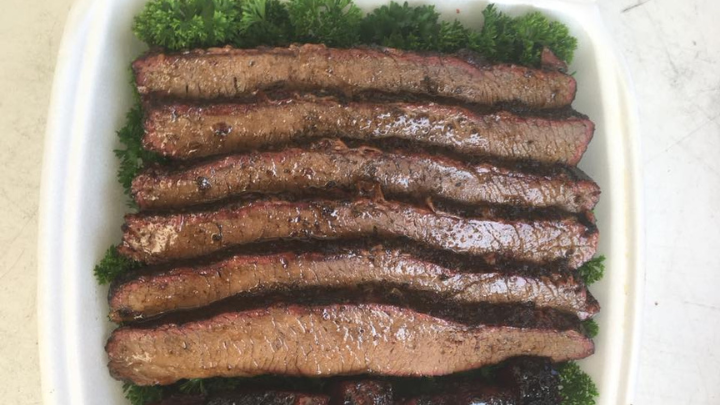 A plate of six barbecued beef brisket slices
